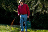 Roger Cook spraying compost tea to fertilize a lawn