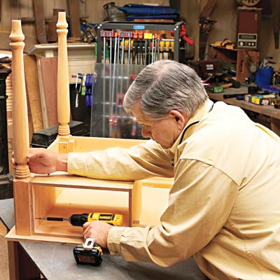 Tom Silva attaches the cubby to the underside of the desk