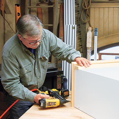 Tom Silva adds trim to the bookcase/cabinet