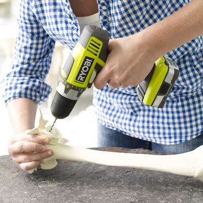 drilling a pilot hole into a fake bone