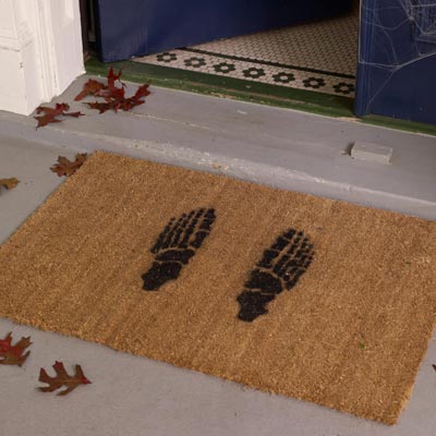 a skeleton-feet stenciled doormat