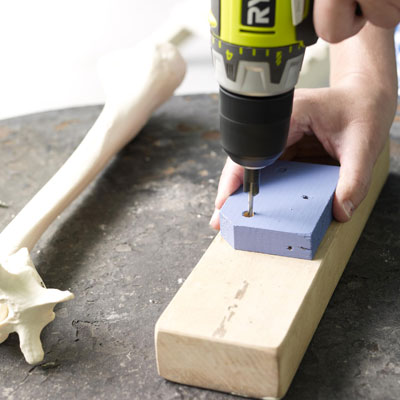 drilling pilot holes into the mounting block