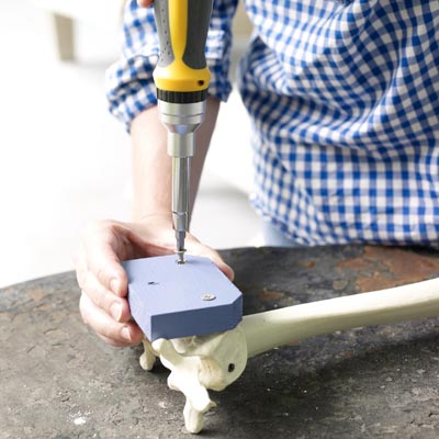 fastening the mounting block to the fake bones