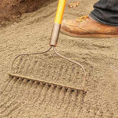 rake used to lay the leveling sand to build a stone planter