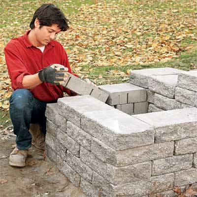 lay the final courses to build a stone planter