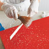 Splatter paint on furniture using a wood stick 