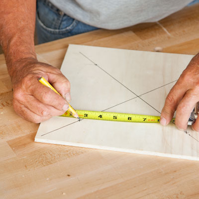 Tom Silva marks an 'X' for the next bottle hole
