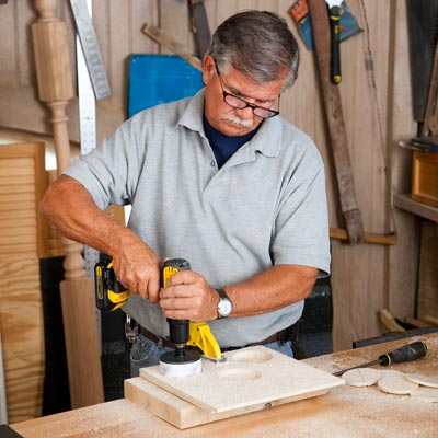 Tom Silva cuts the bottle holes with a hole saw