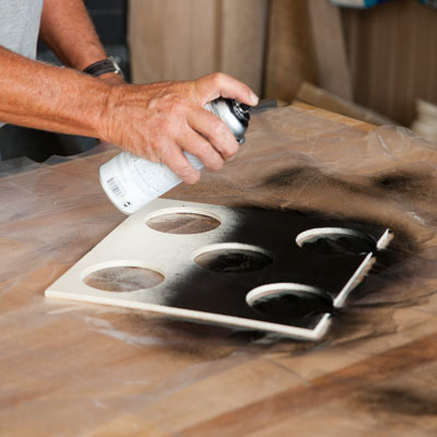 Tom Silva spray paints the bottle hole insert black