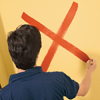 to paint a color wash step two: paint a large x on the wall