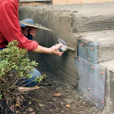 add the scratch coat to clad concrete steps in stone