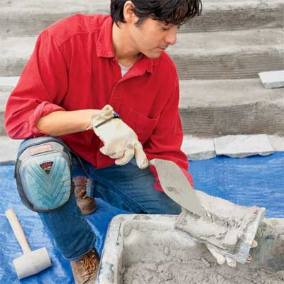 apply morter to clad concrete steps in stone