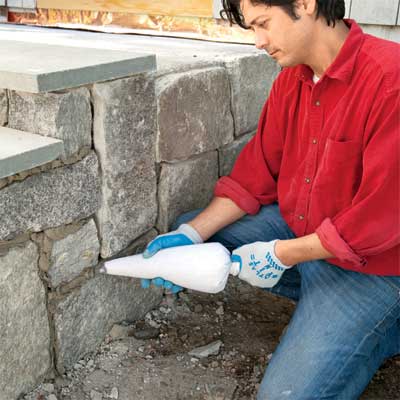 grout the stones to clad concrete steps in stone