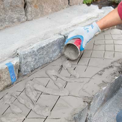 add a slurry mix to clad concrete steps in stone