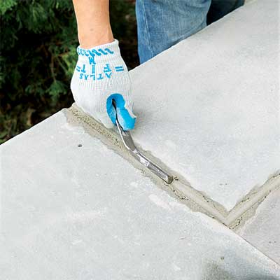 grout the joints to clad concrete steps in stone