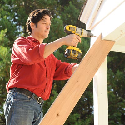 person adding supports to porch awning