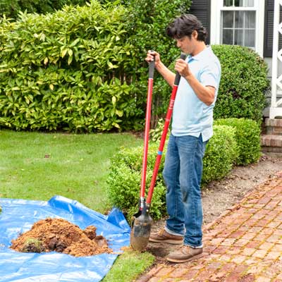 digging the postholes to build a garden gate