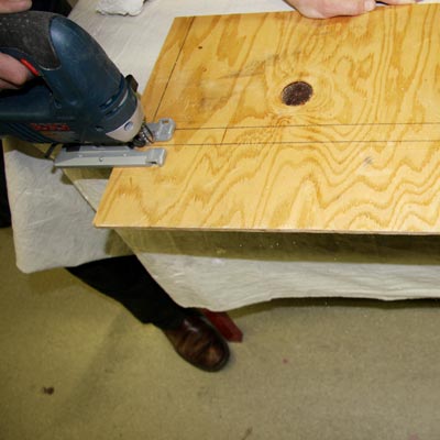 cutting the plywood chalkboard frame with a jigsaw