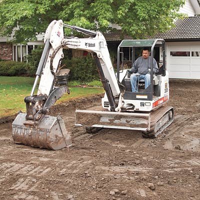 excavating a new driveway with a backhoe