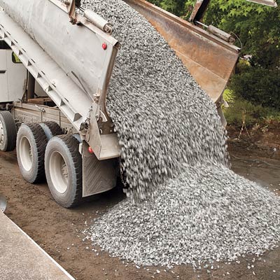 unloading gravel into a new driveway for the base layer
