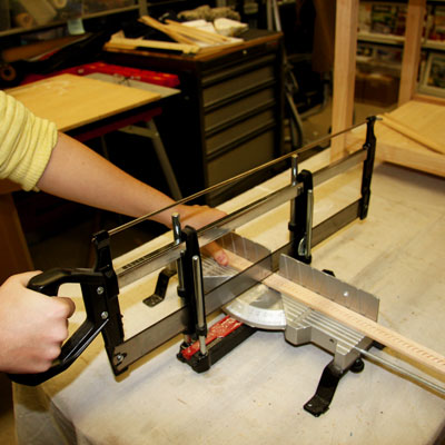 cutting molding using a hand miter saw with a stop block