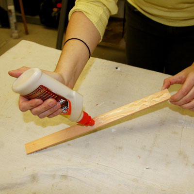 applying glue to a the back of a piece of trim