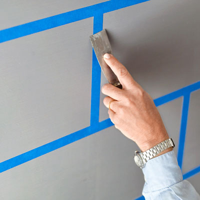 sealing the painter's tape edges with a putty knife