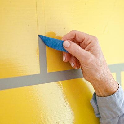 removing the painter's tape to reveal the 