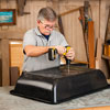 Tom Silva drills holes in a plastic tub for drainage
