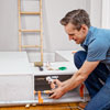 fastening the carcass pieces together inside the bedroom for a storage bed