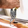 cutting the downspout holes for installing half-round gutters
