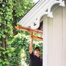 installing a half-round gutter on a house