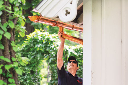 installing a half-round gutter on a house