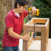 Mark Powers attaches the base plates to the bottom of the planter frame