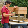 Mark Powers fastens 1x6 boards to the planter