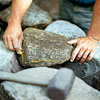 marking stones to cut for building a fieldstone wall