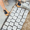 laying the cobblestone mats in the driveway apron