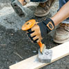 trimming a cobblestone with hand sledge and chisel for a driveway apron
