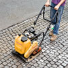 compacting a cobblestone driveway apron with a plate compactor