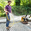 spraying a cobblestone driveway apron with water to prevent grout from sticking to the top