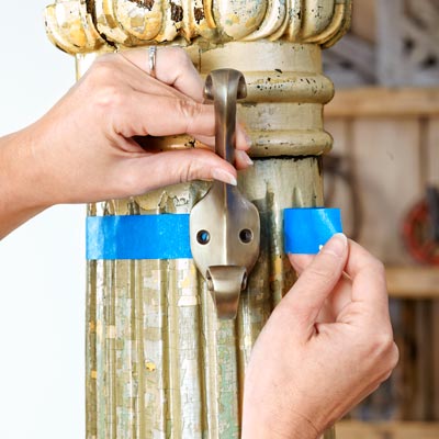 painter's tape marks the diameter of an antique column for hanging hooks