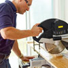 cutting wood slats for a herringbone floor with a miter saw