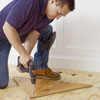 fixing a triangular nailing blank to the subfloor for a herringbone floor install