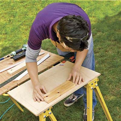 Position the scrap against one of the lines on the plywood