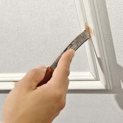 Using a small putty knife fill any nail holes with putty