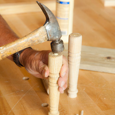 hammering dowels into the upper table legs