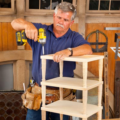Tom Silva attaching the top tier to a 3-tiered side table