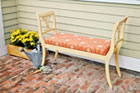 a finished garden bench made from 2 harp-backed dining room chairs