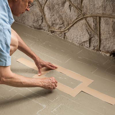 staggering and tracing the colorful carpet template on the porch floor