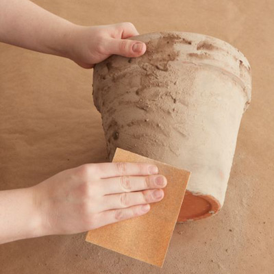 age a terra cotta pot sand away some of the lime mixture on pot